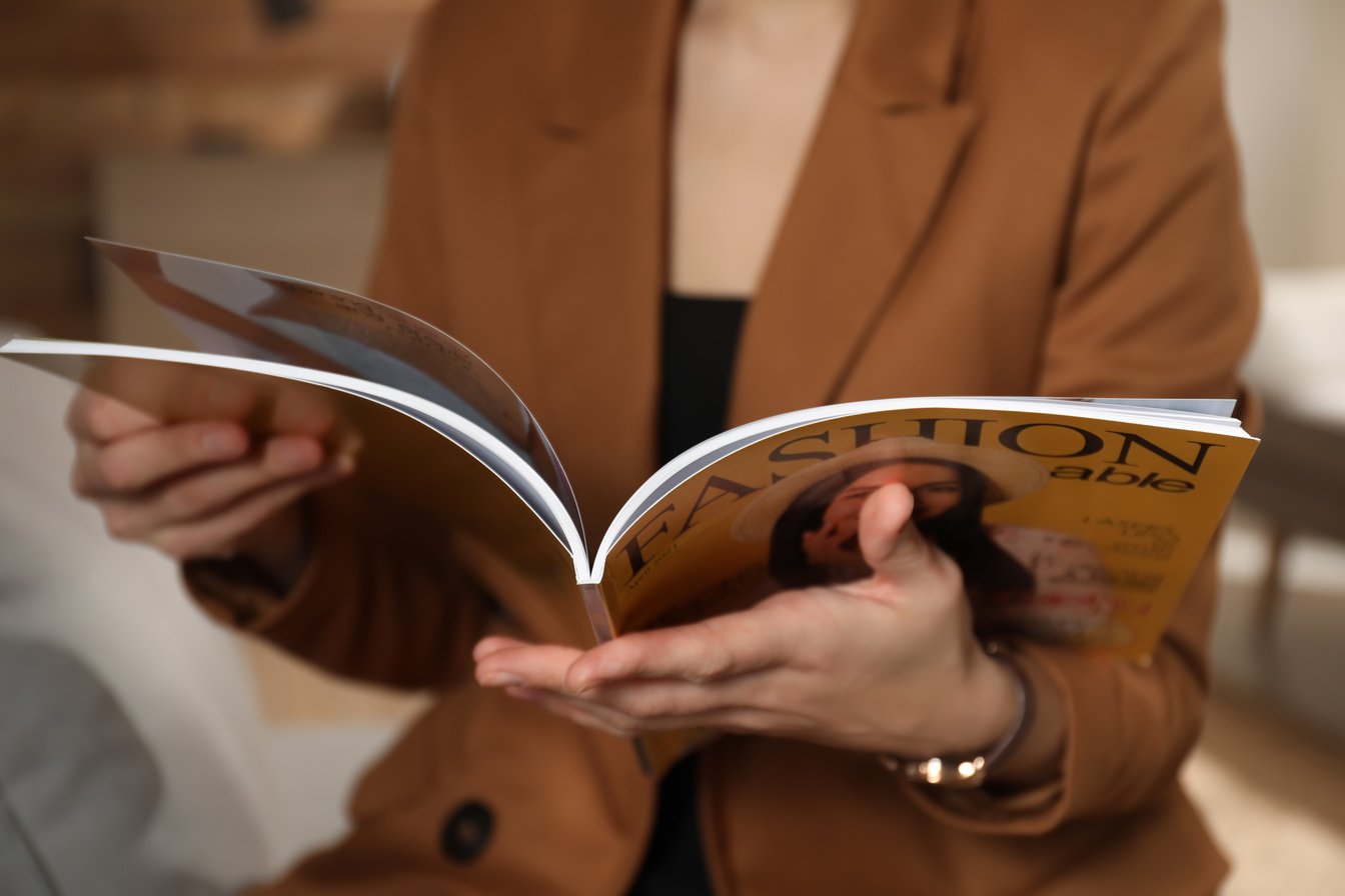 Woman Reading Fashion Magazine at Home, Closeup