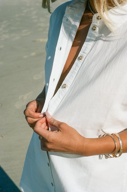 Woman Undressing Shirt at the Beach